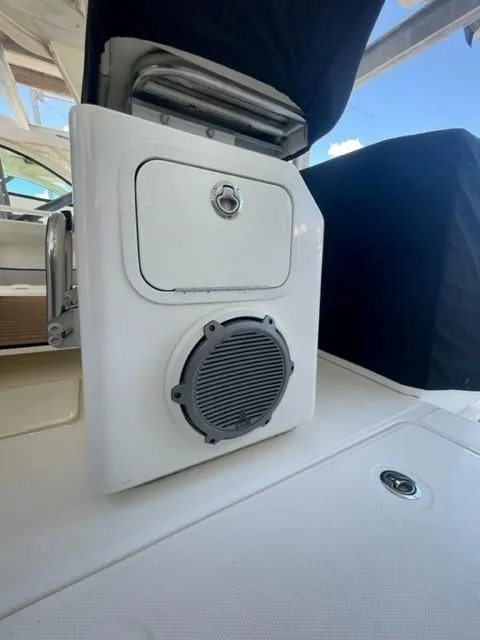 Slide: The Image of 2018 Boston Whaler 420 Outrage boat interior with speaker and storage compartment. - 39