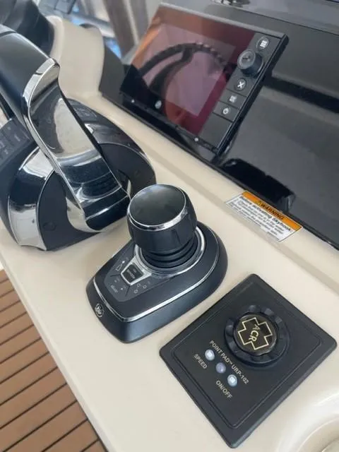 Slide: The Image of 2018 Boston Whaler 420 Outrage helm controls with joystick and display screen. - 43