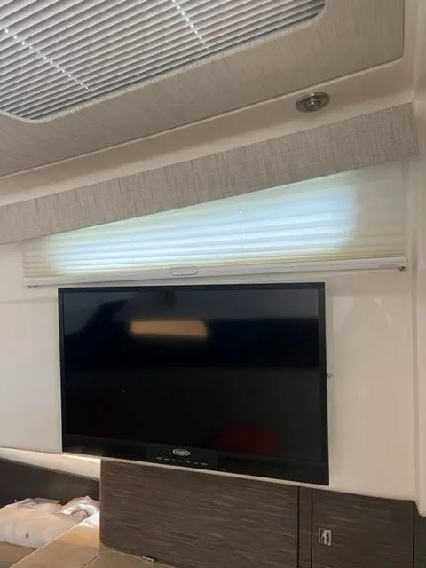 Slide: The Image of Interior of a 2018 Boston Whaler 420 Outrage with a mounted flat-screen TV. - 46