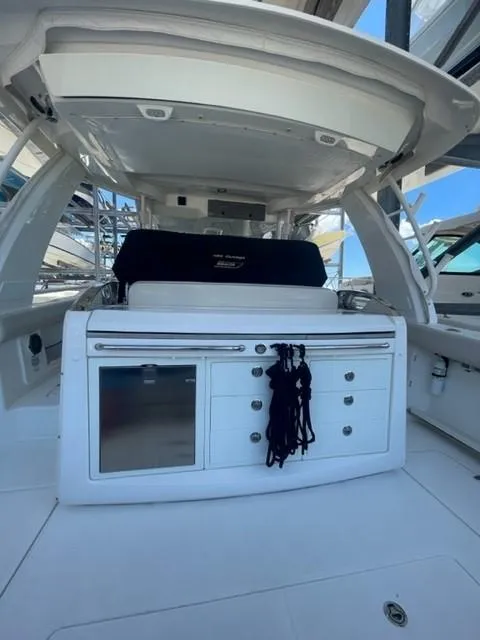 Slide: The Image of 2018 Boston Whaler 420 Outrage interior with storage and seating area. - 6