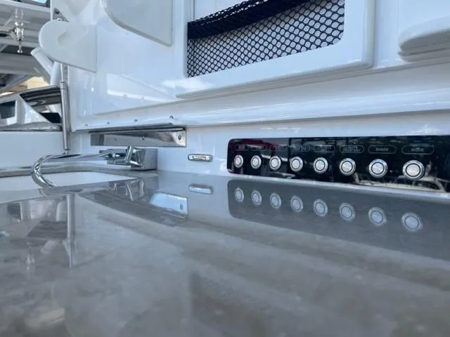 Slide: The Image of 2018 Boston Whaler 420 Outrage interior with control panel and sleek countertop. - 7