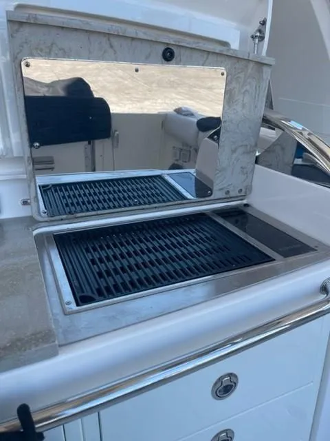 Slide: The Image of Outdoor grill station on 2018 Boston Whaler 420 Outrage boat, featuring stainless steel finish. - 8