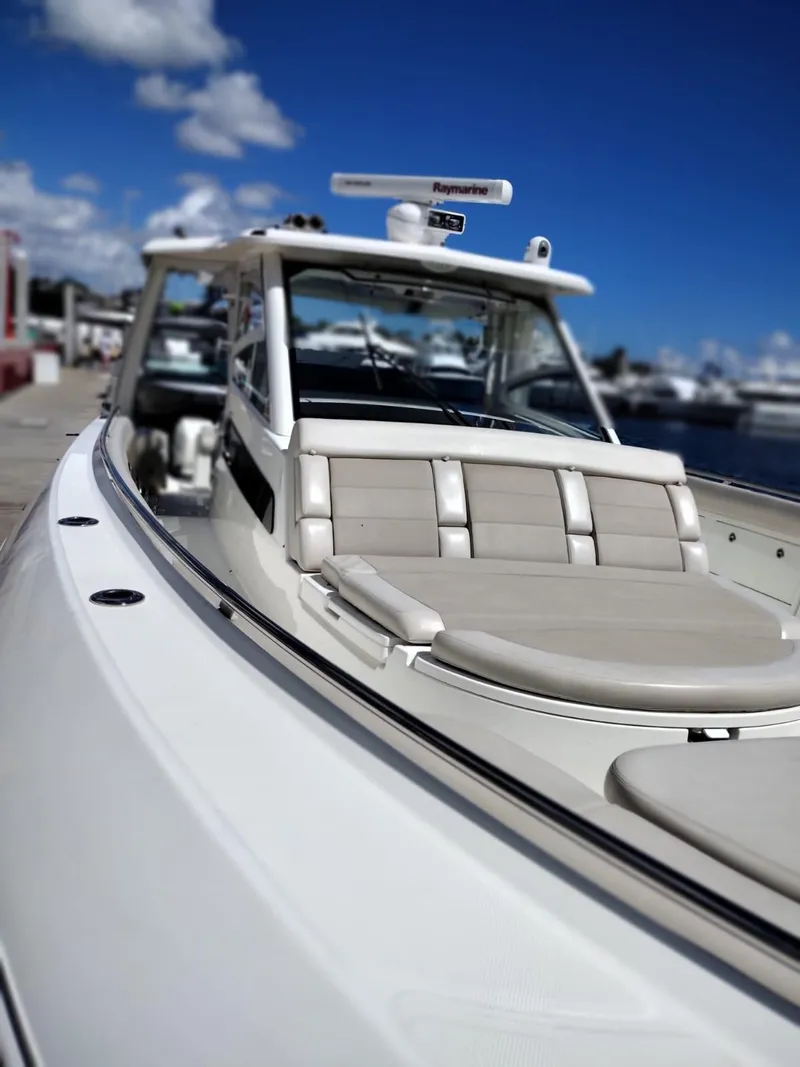 Slide: The Image of 2018 Boston Whaler 420 Outrage boat docked under clear blue sky. - 9