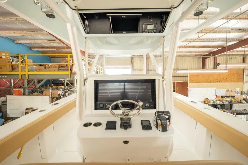 Slide: The Image of 2020 Bahama 41 Open Fisherman boat helm station in a warehouse. - 4