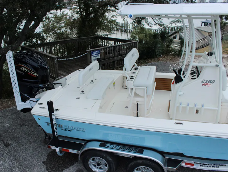 Slide: The Image of 2024 Pathfinder 2300 HPS boat on trailer, rear view with outboard motor. - 13