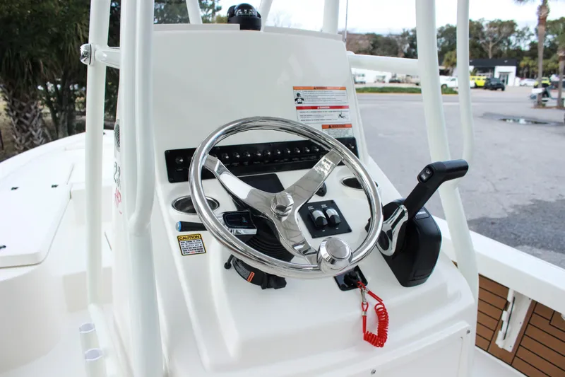 Slide: The Image of 2024 Pathfinder 2300 HPS boat console with steering wheel and controls. - 3