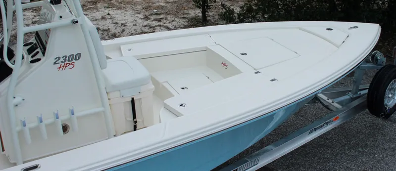 Slide: The Image of 2024 Pathfinder 2300 HPS boat on trailer, white and blue exterior. - 9