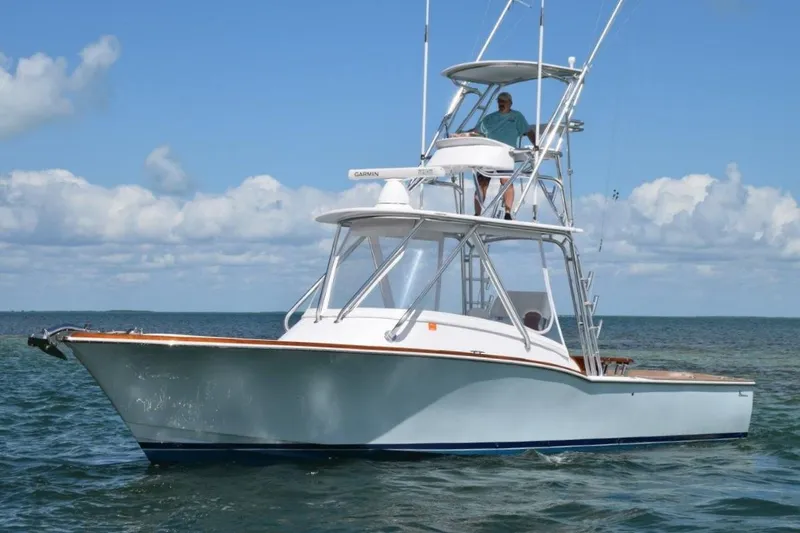 The Image of 2024 L&H Walk-Around Sportfish boat on the water with a person on the upper deck. - 0