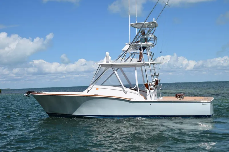 Slide: The Image of 2024 L&H Walk-Around Sportfish boat on open water under blue sky. - 3