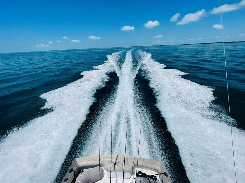 Slide: The Image of 2024 L&H Walk-Around Sportfish boat cruising on open water, leaving a wake trail. - 39