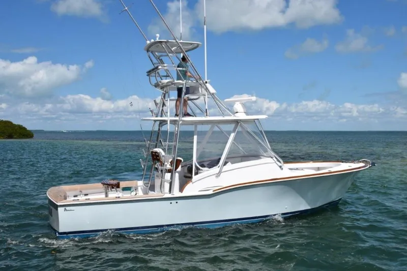Slide: The Image of 2024 L&H Walk-Around Sportfish boat on open water under blue sky. - 4