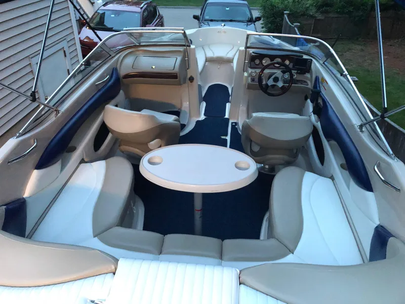 Slide: The Image of 2005 Glastron GX 235 boat interior with seating and table. - 3