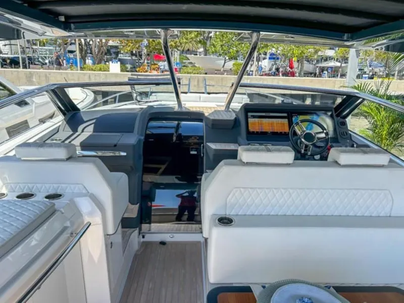 Slide: The Image of 2024 Windy 40 Camira SX boat interior with modern dashboard and white seating. - 10