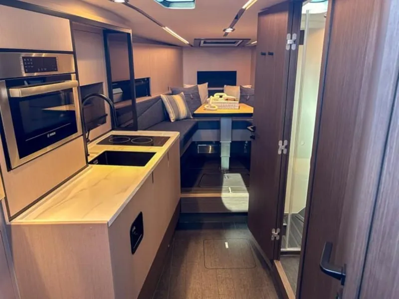 Slide: The Image of Modern interior of 2024 Windy 40 Camira SX yacht with kitchen and dining area. - 11