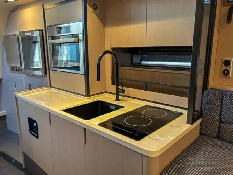 Slide: The Image of Modern kitchen in 2024 Windy 40 Camira SX yacht with sleek appliances and induction cooktop. - 13