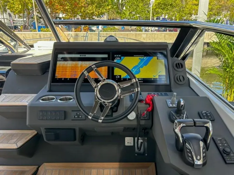 Slide: The Image of 2024 Windy 40 Camira SX helm with dual navigation screens and modern controls. - 6