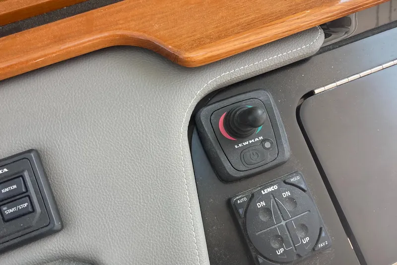 Slide: The Image of Control panel of a 2019 Tiara Sport 38 boat with joystick and switches. - 18