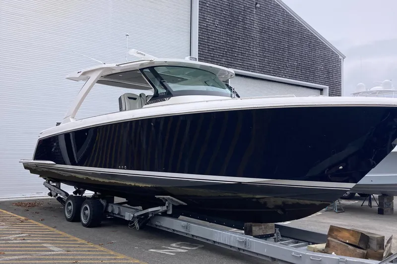Slide: The Image of 2019 Tiara Sport 38 boat on a trailer outside a warehouse. - 2