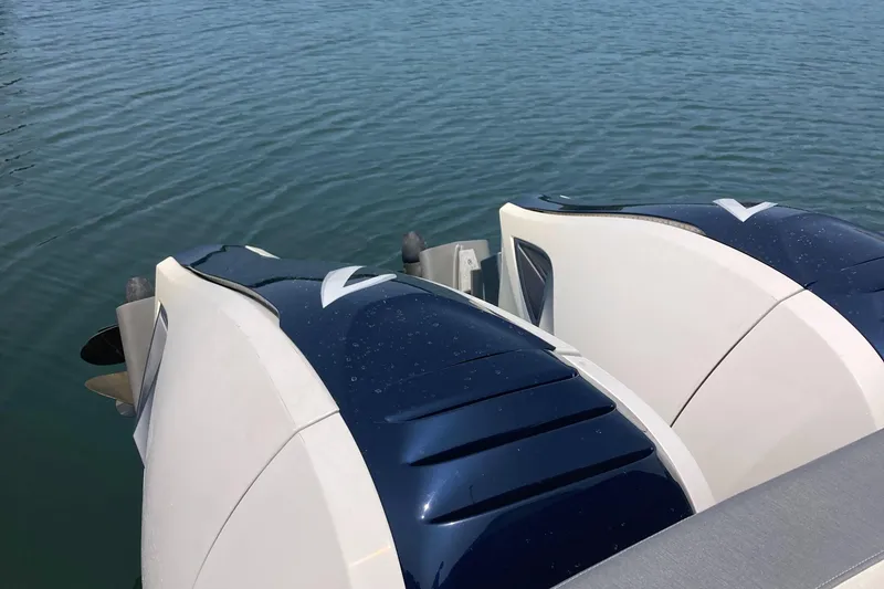 Slide: The Image of Twin outboard engines on a 2019 Tiara Sport 38 boat, floating on calm water. - 21
