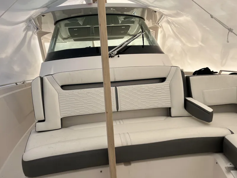 Slide: The Image of 2019 Tiara Sport 38 boat interior with white and gray seating. - 25