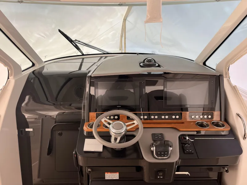 Slide: The Image of Helm of 2019 Tiara Sport 38 boat with modern controls and steering wheel. - 27