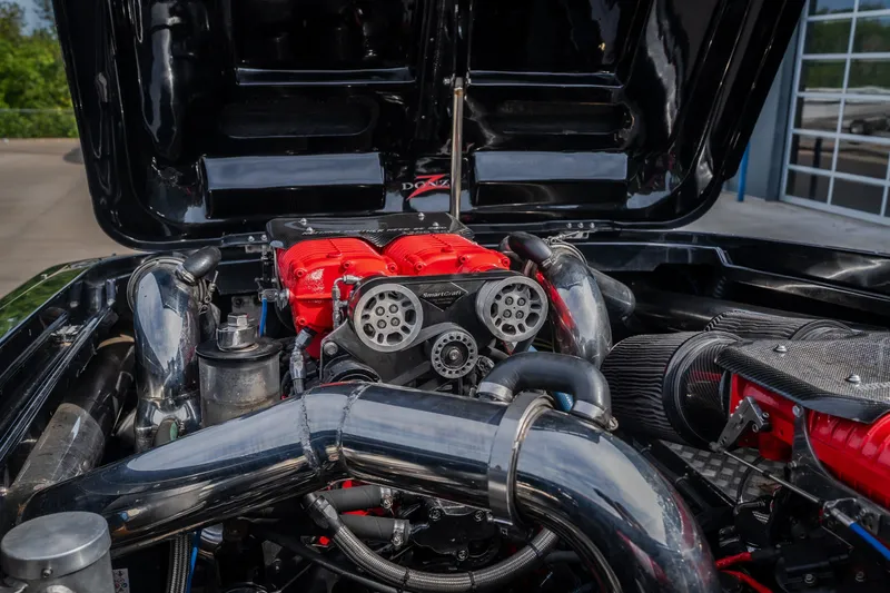 Slide: The Image of High-performance engine of a 2009 Donzi 38 ZRC boat with red accents and chrome components. - 44