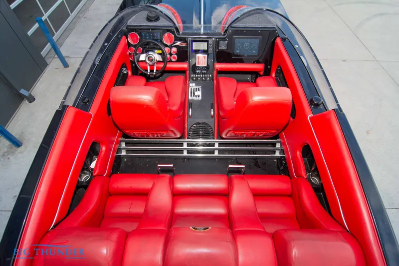 Slide: The Image of 2009 Donzi 38 ZRC boat interior with red leather seats and modern dashboard. - 18