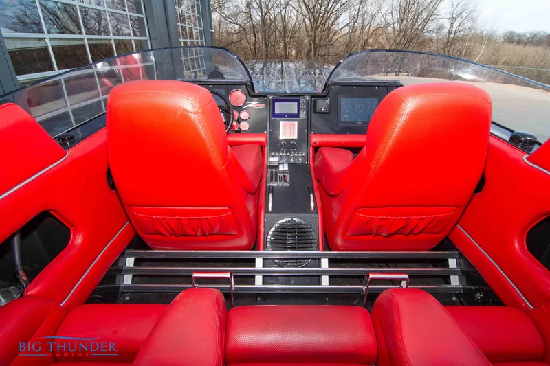 Slide: The Image of 2009 Donzi 38 ZRC boat interior with red seats and modern dashboard. - 19