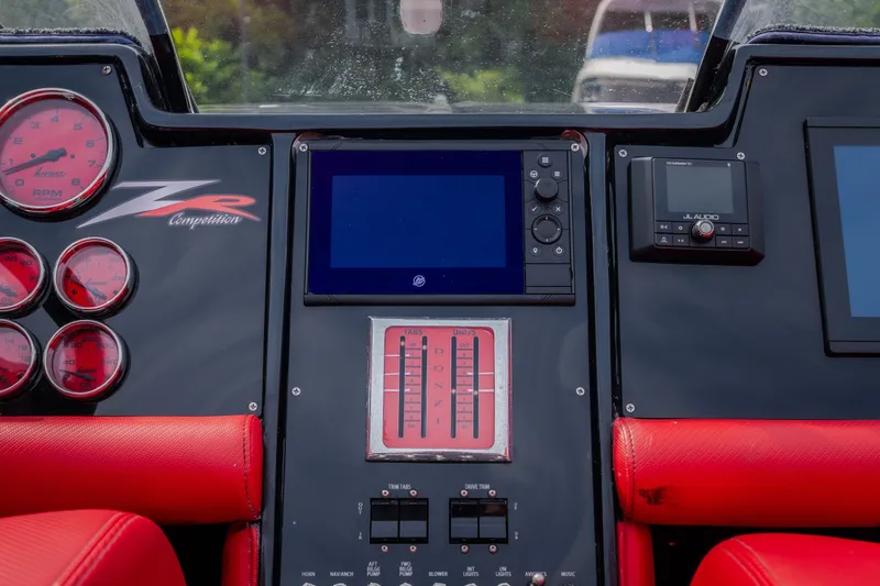 Slide: The Image of Dashboard of a 2009 Donzi 38 ZRC boat with red gauges and controls. - 41