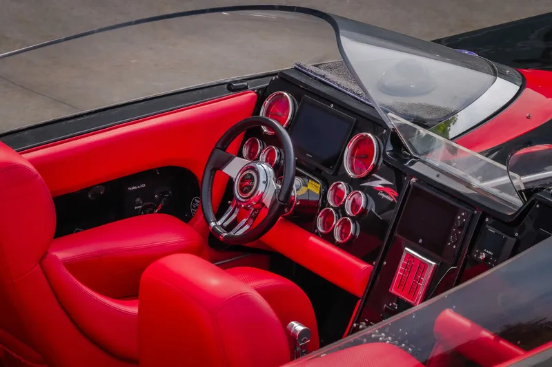 Slide: The Image of Red interior of 2009 Donzi 38 ZRC boat with sleek dashboard and steering wheel. - 16