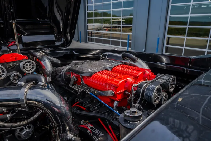 Slide: The Image of High-performance engine of a 2009 Donzi 38 ZRC boat, featuring vibrant red components. - 43