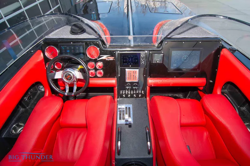 Slide: The Image of 2009 Donzi 38 ZRC boat cockpit with red seats and advanced control panel. - 28