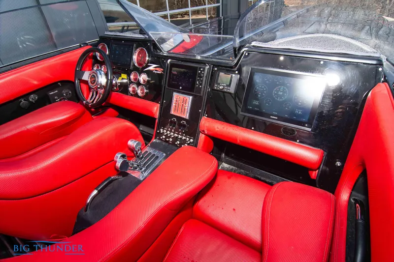 Slide: The Image of 2009 Donzi 38 ZRC boat interior with red seats and advanced dashboard controls. - 29
