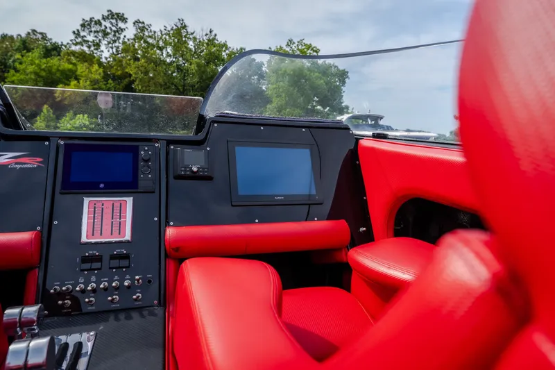 Slide: The Image of Interior of 2009 Donzi 38 ZRC boat with red seats and control panel. - 39