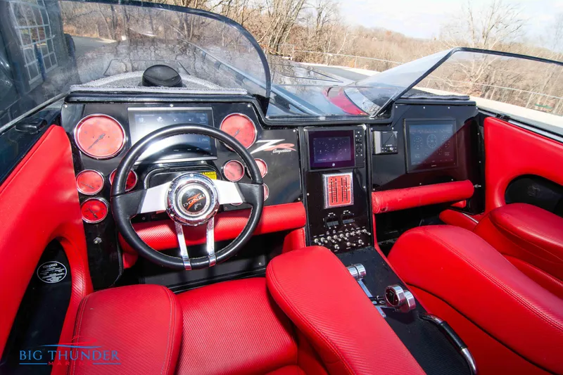 Slide: The Image of 2009 Donzi 38 ZRC boat cockpit with red leather seats and modern dashboard. - 30