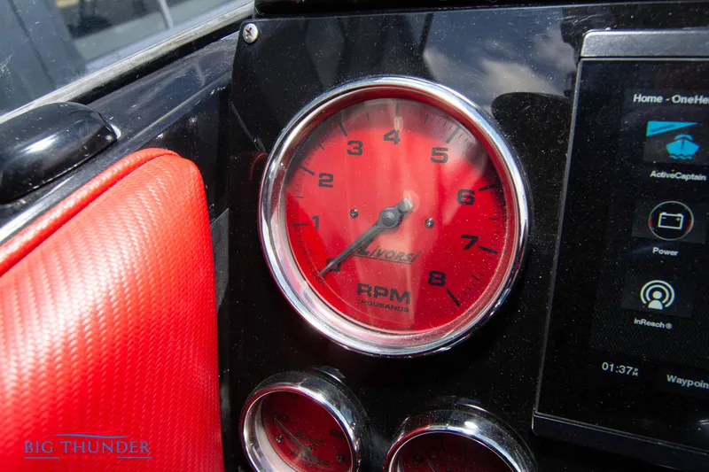 Slide: The Image of Close-up of the 2009 Donzi 38 ZRC tachometer and dashboard controls. - 32