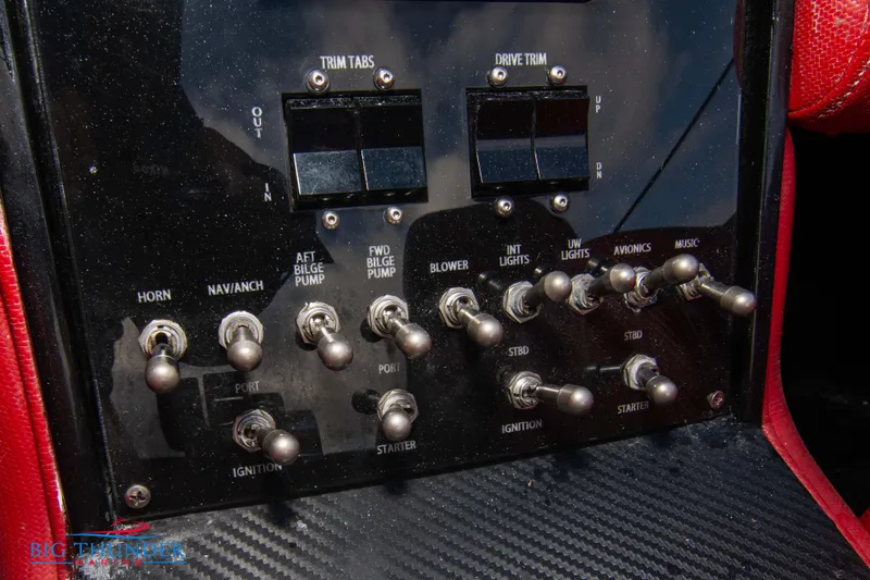 Slide: The Image of Control panel of a 2009 Donzi 38 ZRC boat with various switches and indicators. - 37