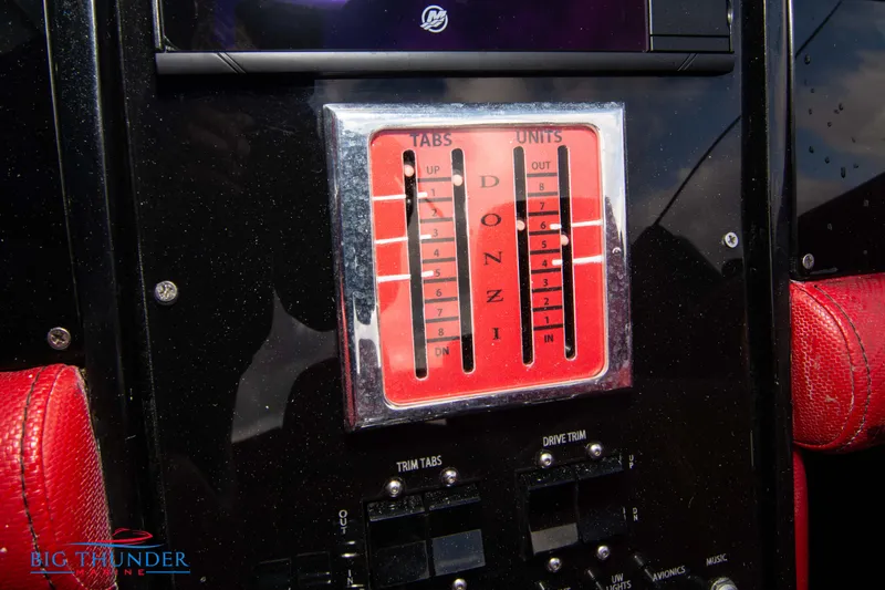 Slide: The Image of Control panel of a 2009 Donzi 38 ZRC boat with trim tabs and drive trim. - 38