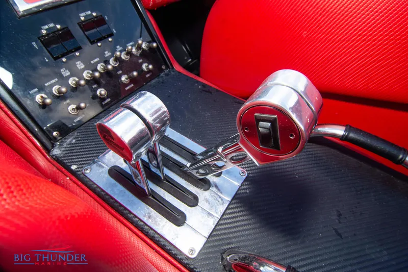 Slide: The Image of 2009 Donzi 38 ZRC boat controls and dashboard with red interior. - 39