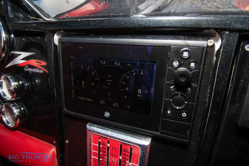 Slide: The Image of Dashboard of a 2009 Donzi 38 ZRC boat with digital display and controls. - 42