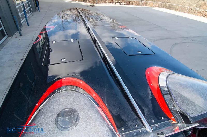 Slide: The Image of 2009 Donzi 38 ZRC powerboat with sleek black and red design on trailer. - 46
