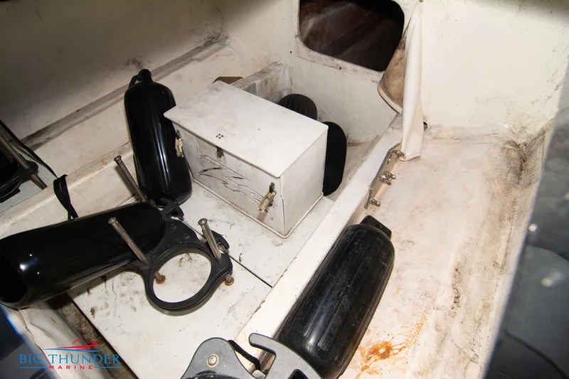 Slide: The Image of Interior of a 2009 Donzi 38 ZRC boat with storage compartment and black fenders. - 48