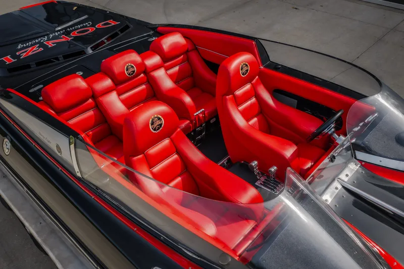 Slide: The Image of 2009 Donzi 38 ZRC boat interior with vibrant red leather seats and sleek design. - 20