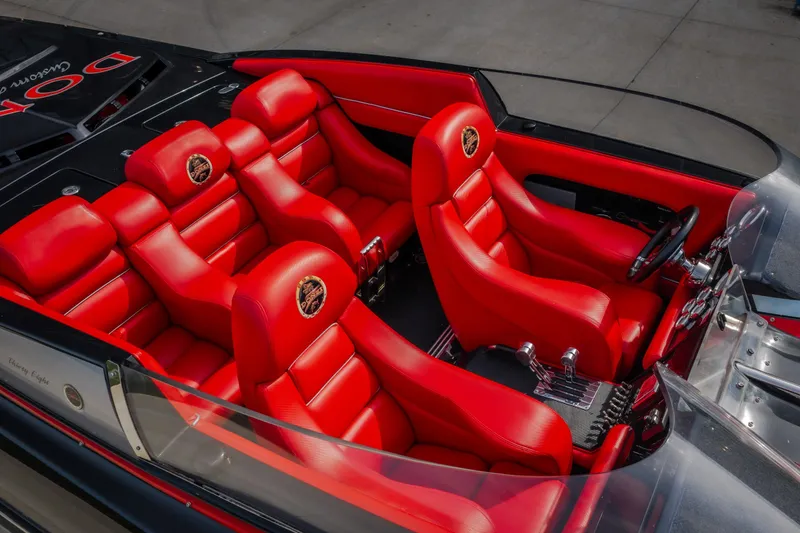 Slide: The Image of 2009 Donzi 38 ZRC boat interior with vibrant red leather seats and sleek design. - 19