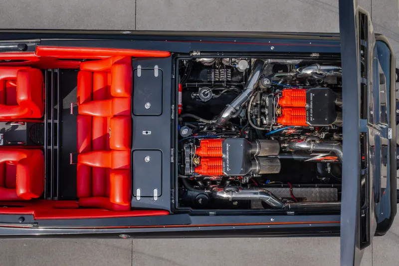 Slide: The Image of 2009 Donzi 38 ZRC boat interior with red seating and dual Mercury engines. - 25