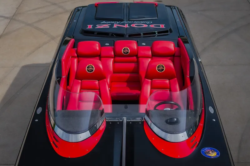 Slide: The Image of 2009 Donzi 38 ZRC boat with red seats and sleek black design. - 14