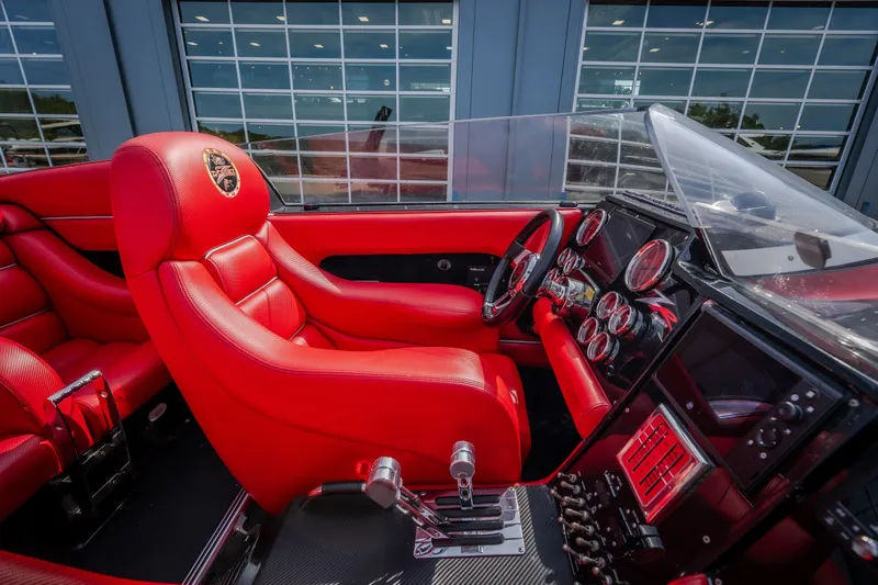 Slide: The Image of Interior of 2009 Donzi 38 ZRC boat with vibrant red seating and detailed dashboard. - 30