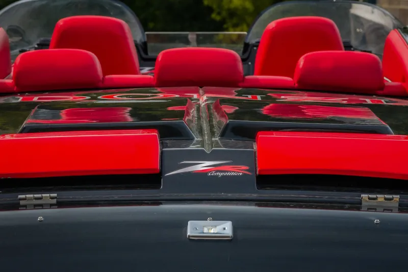 Slide: The Image of 2009 Donzi 38 ZRC boat with red seats and sleek black design. - 18