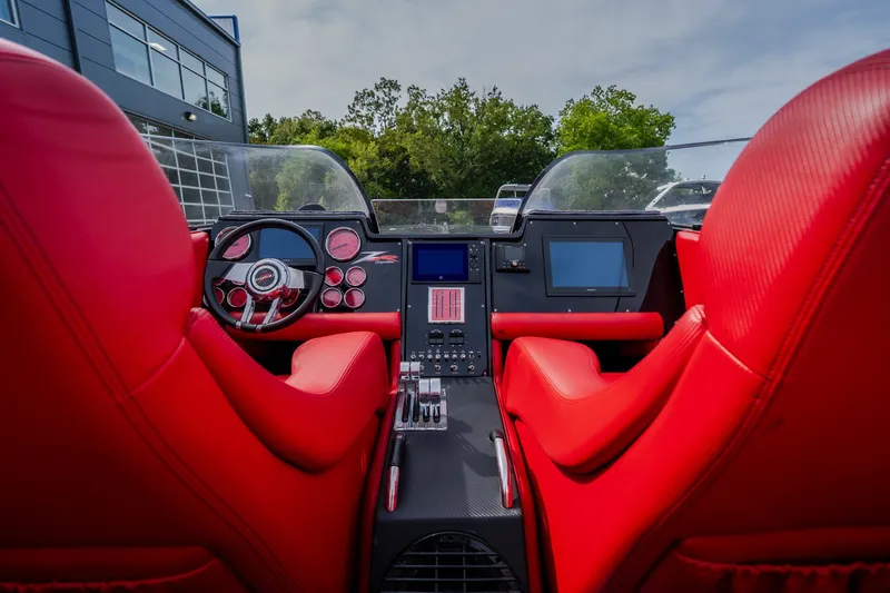 Slide: The Image of Interior of 2009 Donzi 38 ZRC boat with red seats and modern dashboard. - 37