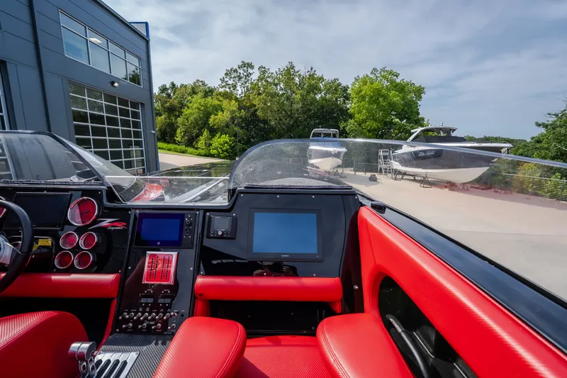 Slide: The Image of 2009 Donzi 38 ZRC boat cockpit with red seats and modern dashboard. - 49